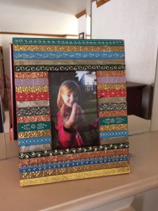 Mantle with decorative frame and our beautiful niece K.