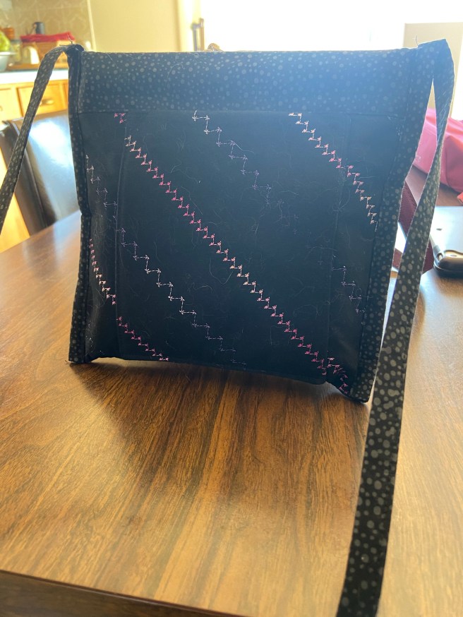 A small, black, cloth bag