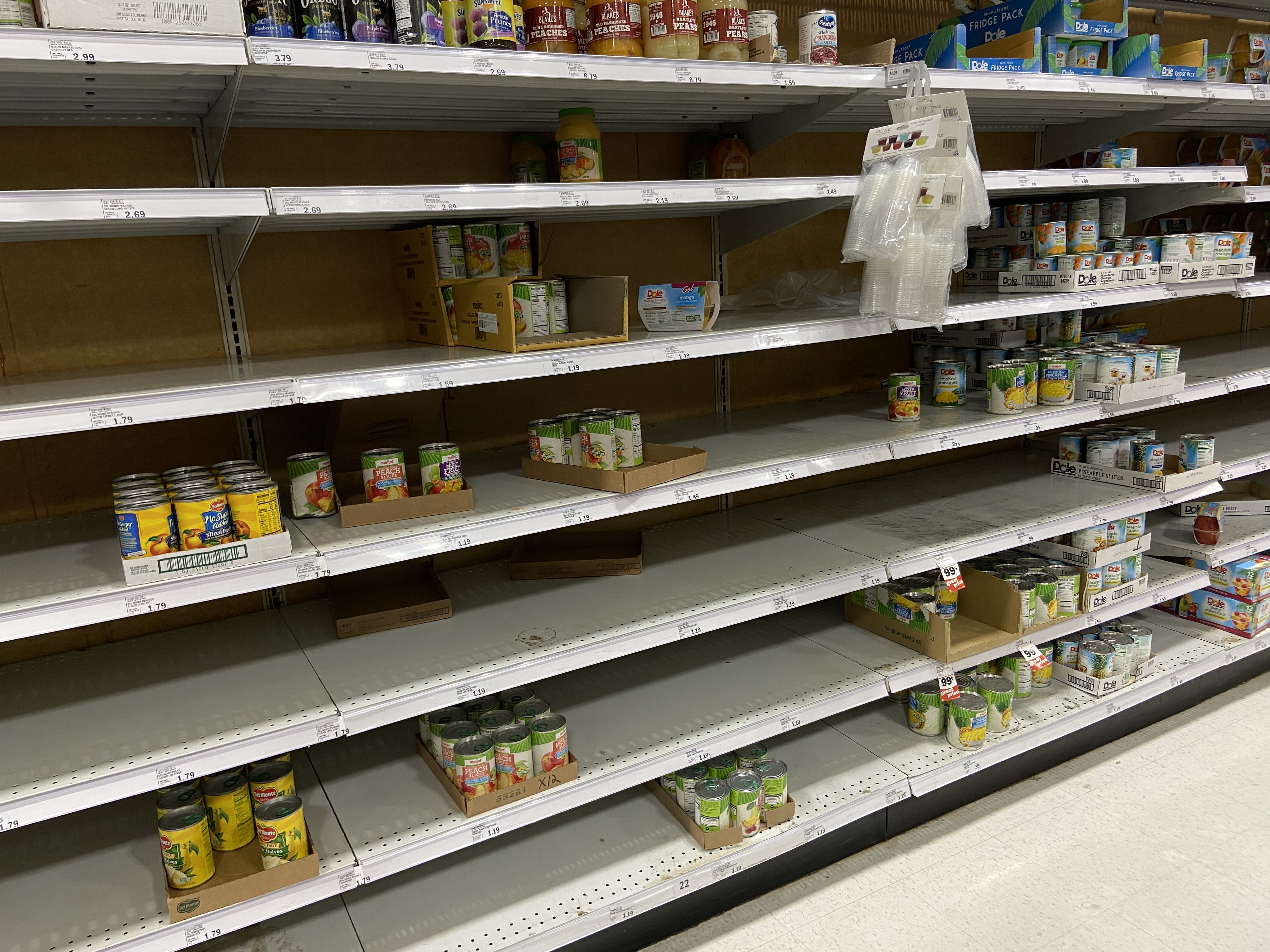 mostly empty canned fruit shelves